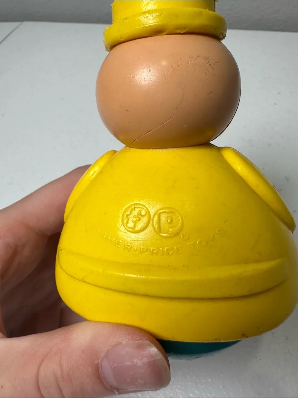 Fisher-Price Yellow Roly-Body Toy with Peach Face and Blue Base
